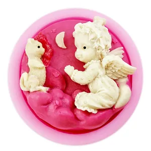 Macro view of detailed relief design featuring an angel and cat on pink silicone mold