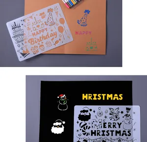 Hollow painting stencils for DIY birthday and Christmas cards shown on paper.