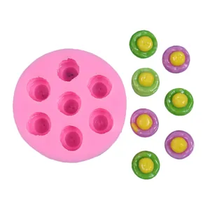Detail view of a pink 7-cavity silicone mold with colorful mini dessert samples