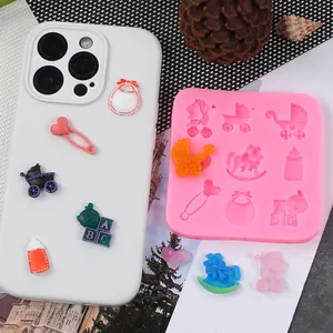 Detailed macro view of baby-themed silicone mold with finished resin charms on a phone case