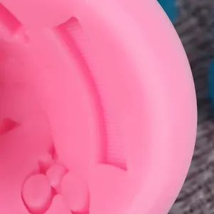 Close-up macro view of a pink silicone hair tool mold for fondant cake decoration