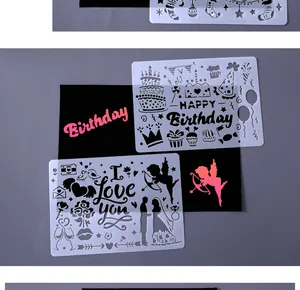 Close-up of hollow DIY painting stencils with Birthday and Love themes on gray background
