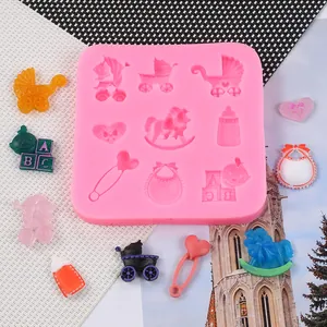 Detail of baby-themed silicone fondant mold showing stroller and rocking horse shapes
