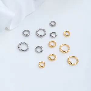 Detailed macro view of gold and silver stainless steel pig nose connector rings for DIY