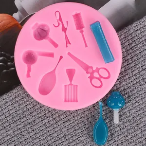 Detailed view of pink salon tools silicone mold with combs scissors and dryer shapes