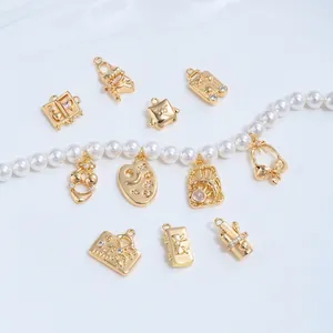 Detailed view of 14K gold-plated travel themed charms for DIY necklace and bracelet.