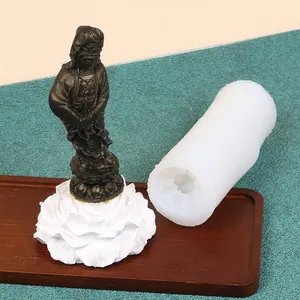 Detail of translucent silicone mold next to finished Guanyin Bodhisattva plaster statue