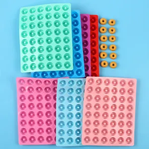 Detail showing various colorful multi-cavity silicone molds for mini donut baking