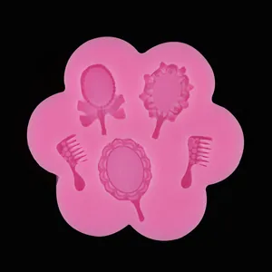 Detailed close-up view of a pink silicone mold with mirror and comb shaped cavities.