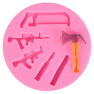 Moule détaillé en silicone rose avec formes de fusils et outils pour décoration
