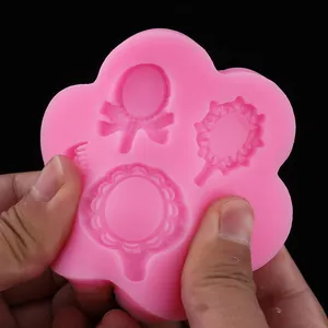 Detail of pink flexible silicone mold featuring vintage mirror shapes for DIY cake decorating