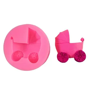 Macro detail of baby stroller silicone mold with finished pink fondant stroller