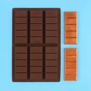 Top view detail of a 6-cavity rectangular chocolate silicone mold on blue background