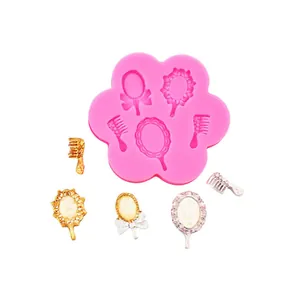 Pink silicone mold featuring mini mirrors and combs for detailed cake decorations.
