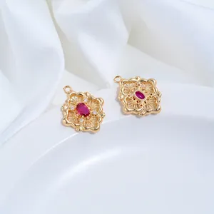 Detailed close-up view of 14K gold-filled vintage floral pendant with red oval zircon