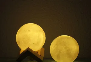Realistic 3D moon lamp with warm yellow light and wooden stand on dark background