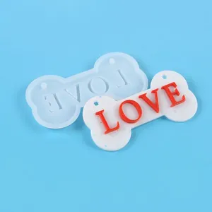 Detailed dog bone resin mold showing 14.5cm size markings and finished LOVE pet tag