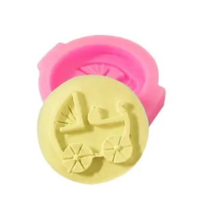 Detail of pink baby carriage silicone mold with yellow fondant sample on white background.