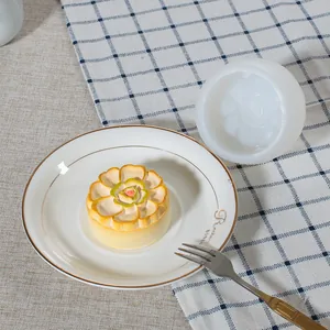 White silicone flower mold displayed alongside a detailed floral candle finished product