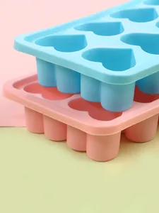 Macro view of 10-cavity heart-shaped silicone ice cube trays in pink and blue colors.