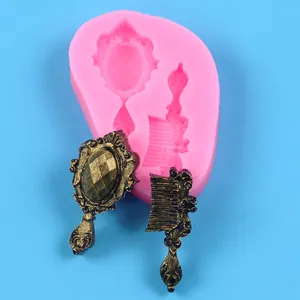 Macro detail of pink silicone mold featuring vintage mirror and comb shapes for DIY crafts