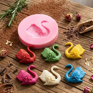 Detailed view of the 3D rose swan silicone mold alongside colorful finished chocolate shapes