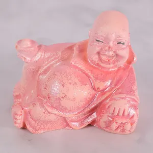 Close-up of pink glittery reclining Laughing Buddha figurine for DIY candle projects.