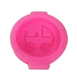 Macro view of a pink liquid silicone mold with detailed baby stroller pattern for fondant