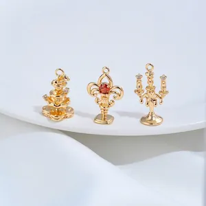 Close-up of 14K gold plated fountain and candelabra charms for DIY jewelry making