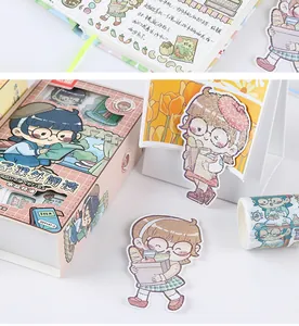 Close-up of cute cartoon girl stickers with glitter finish and matching washi tape set