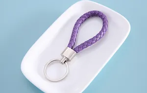 Close-up of a purple braided leather keychain with silver metal ring