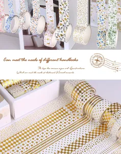 Detailed macro view of gold foil washi tape patterns and gift box packaging