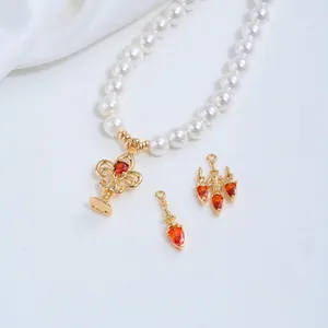 Detail view of 14K gold plated crystal lamp fountain pendants with orange zircons for DIY.