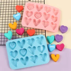 Detail view of blue heart-shaped 10-grid silicone chocolate mold on grid