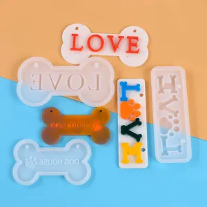 Macro detail view of silicone bone-shaped molds and finished colorful resin pet tags.