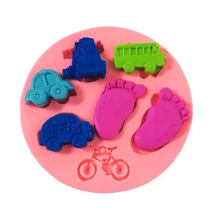 Detailed view of baby themed silicone fondant mold with car and footprint shapes.