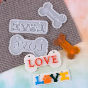 Close-up of bone-shaped pet tag silicone molds and finished resin casting crafts