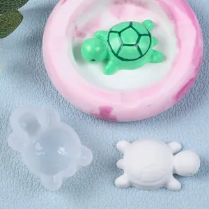 Macro view of DIY mini turtle silicone mold and finished resin turtle pieces.