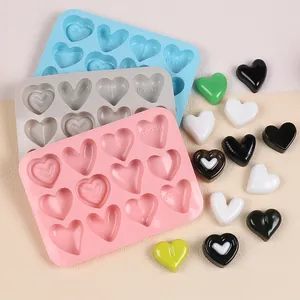 Heart-shaped silicone molds in pink, grey, and blue with 10 cavities for chocolate.