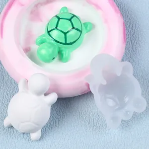 Detail view of a DIY mini turtle silicone mold with finished resin and plaster turtles.