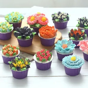 Professional Russian piping tips set creating colorful floral icing designs on cupcakes