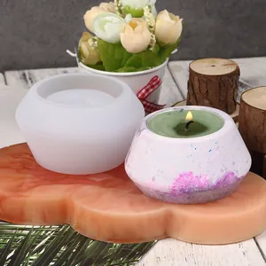 Detailed view of silicone mold and finished purple patterned candle holder for DIY crafts