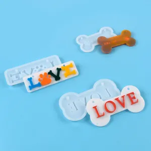 Detail of DIY dog bone and LOVE letter resin molds showing finished tag effects.