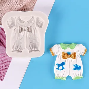 Detail view of a baby romper silicone mold with a finished fondant decoration piece.
