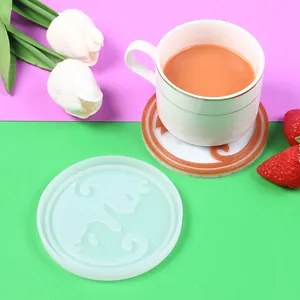 DIY cat pattern resin coaster silicone mold shown with finished coaster and coffee cup