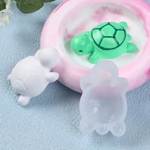 Close-up of translucent turtle silicone mold with green and white resin turtle figurines