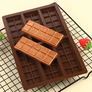 Detail view of 6-cavity silicone chocolate mold with finished rectangular bars on a rack.