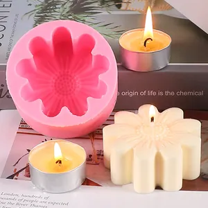 Close-up of pink silicone daisy mold and finished cream floral candle