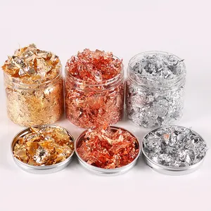 Detailed view of gold, silver, and rose gold metallic foil flakes in jars for DIY crafts.
