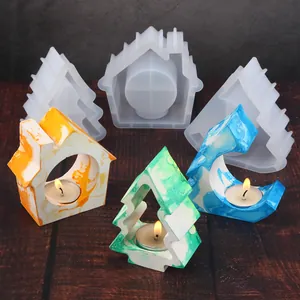 Close-up of DIY Christmas tree and house silicone molds with finished marble candle holders